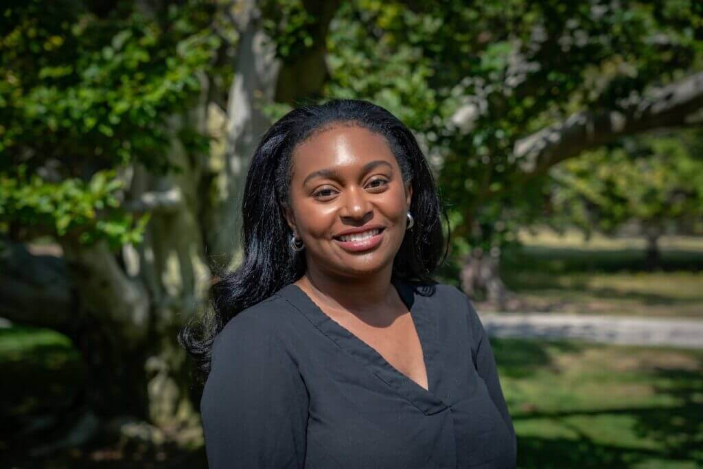 A photo of Assistant Director and Researcher, Mikayla Harden standing outdoors.
