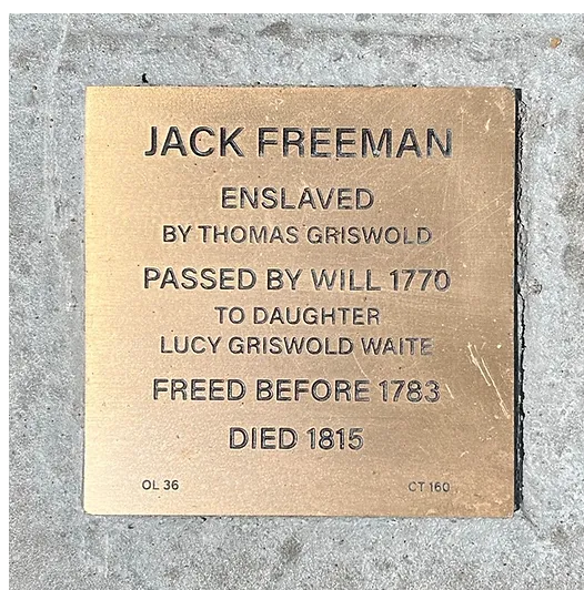Memorial plaque for Jack Freeman, enslaved, freed before 1783, died 1815, honoring historical journey and freedom.