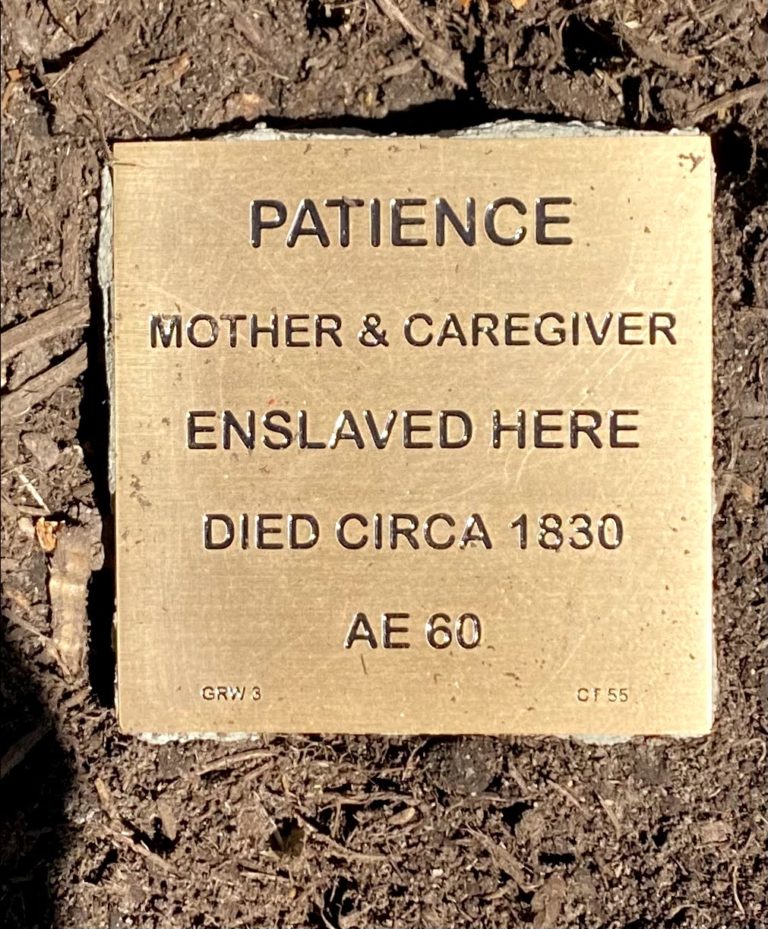 Bronze plaque honoring Patience, a mother and caregiver enslaved, died circa 1830, AE 60, set in the ground.
