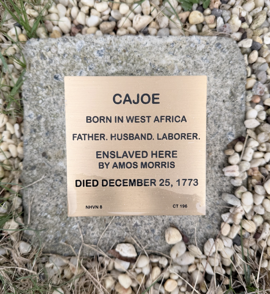 Bronze memorial plaque for Cajoe, a West African laborer enslaved by Amos Morris, died December 25, 1773.