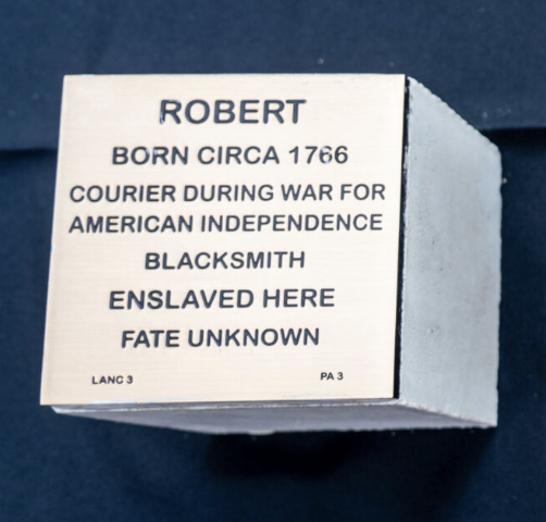 Plaque honoring Robert, born circa 1766, as a Revolutionary War courier and blacksmith, with unknown fate.