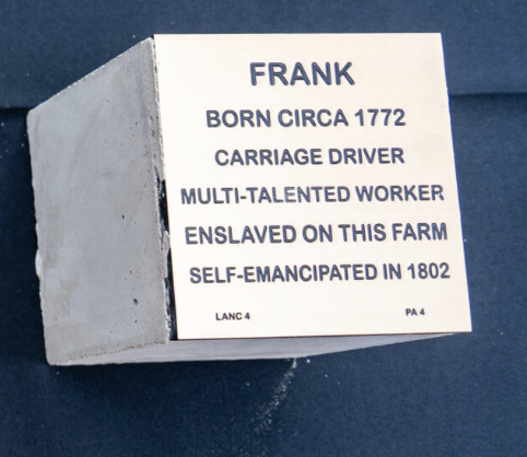 Plaque honoring Frank, born circa 1772, carriage driver, multi-talented, self-emancipated in 1802, once enslaved.