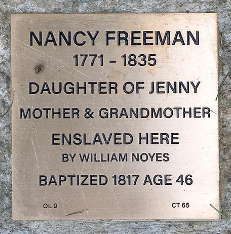 Plaque commemorating Nancy Freeman, enslaved by William Noyes, baptized in 1817, highlighting her family legacy.