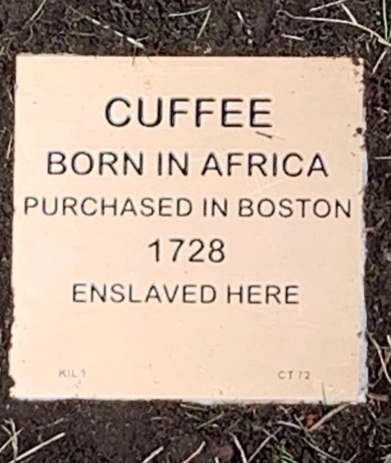 Plaque showing the history of Cuffee's enslavement: Born in Africa, purchased Boston 1728, enslaved here.